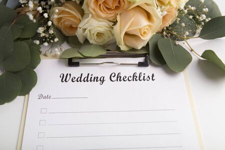 Wedding checklist with empty space for text and roses on backgroundの写真素材