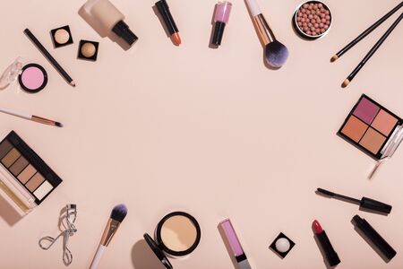 Makeup artist concept. Frame of make up professional products on pink background with copy space for textの写真素材