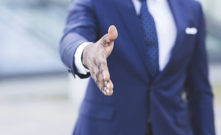 Handshake. Unrecognizable African American Business Guy Stretching Hand For Greeting In Urban Area....