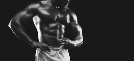 Muscular body demonstrated by african american male bodybuilder, cropped, monochrome, free spaceの写真素材
