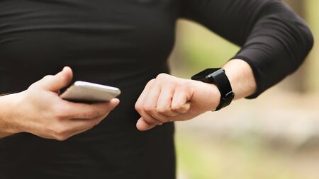 Close-up of Unrecognizable Man Using Fitness App On His Smartwatch To Monitor Workout Performance,...
