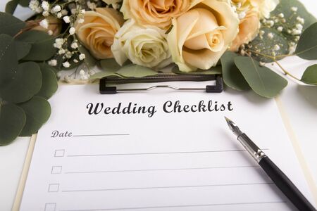 Planning concept. Wedding checklist is ready to be full of items on white sheet of paperの写真素材
