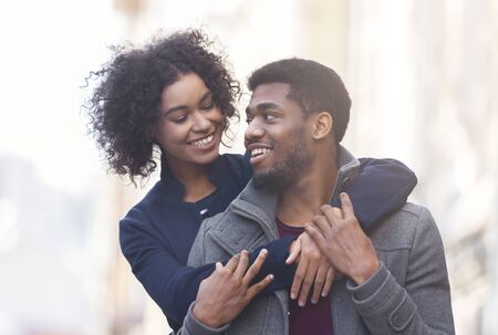 African american young couple enjoying good autumn weather at forest, cuddlingの写真素材