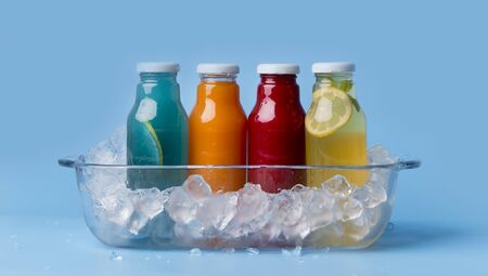 Summer vibes. Different flavoured detox drinks in glass bottles on blue background, panorama