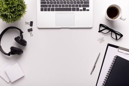 Modern place for work with laptop, headphones and stationery on whiteの写真素材