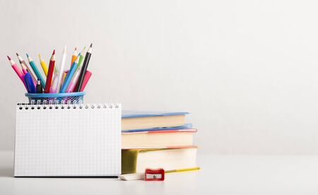 New academic year concept. School and office supplies with books on white background, panorama, copy spaceの写真素材