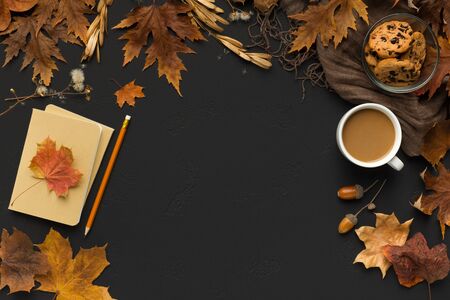 Autumn atmosphere for creation on black background with dry leaves and hot coffee