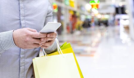 Unrecognizable guy using cellphone to make online order in shop application, panorama, free spaceの写真素材
