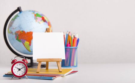 Ready for school. Office stationery with alarm clock on white background, panorama, copy space