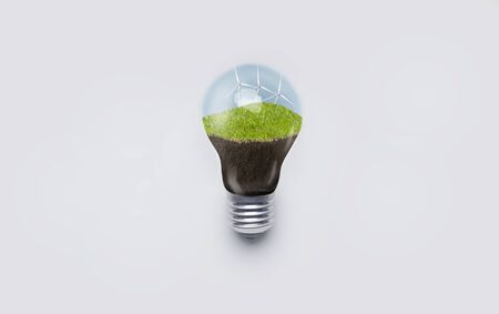 Generating clean electricity. Wind turbines inside of light bulb, isolated on white backgroundの写真素材