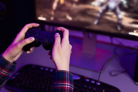Gamer playing video game, holding joystick, focus on hands, free spaceの写真素材