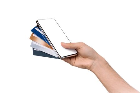 Online banking. Smartphone with blank screen and bunch of credit cards in mans handの写真素材