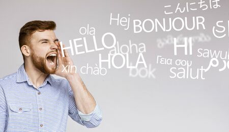 Shouting guy. Crazy emotional man screaming hello in many different languages, panoramaの写真素材