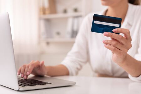 Online Banking. Unrecognizable Office Girl Using Credit Card And Laptop Computer At Workplace.