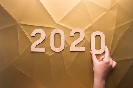 Planning of new 2020 year with wooden numbers on golden creative backgroundの写真素材