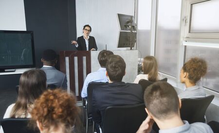 Top manager reading lecture to colleagues at presentation of new project
