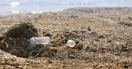 Human work consequences. Fishing net with plastic garbage pollution on seaside, free space