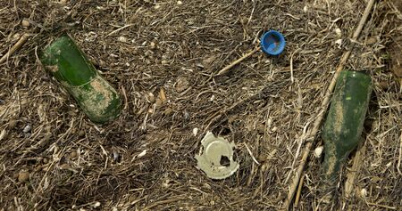 Environment pollution. Lots of plastic and metal trash on seaside, panorama, close upの写真素材