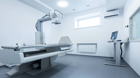 Empty laboratory room with big modern X-Ray machine, hospital equipment, panorama, copy space