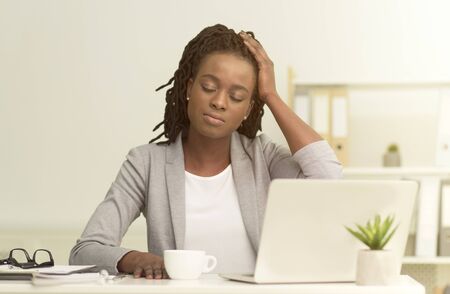 Black Office Lady Having Headache Or Migraine Working On Laptop Computer Sitting At Workplace....