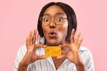 Banking Services. Funny African American Woman Showing Credit Card Standing On Pink Background....