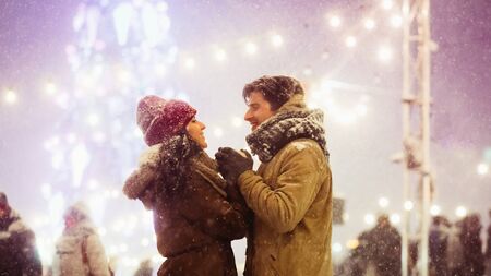 Loving Spouses Holding Hands Celebrating New Year Outdoors Standing In Night City Decorated With...