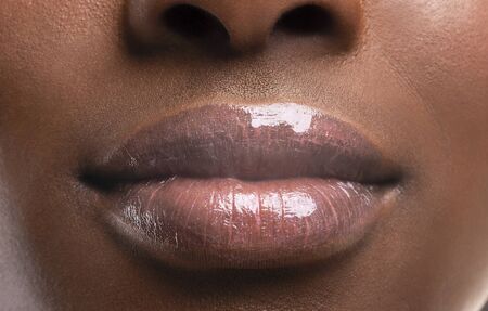 Lip augmentation. Closeup of perfect plump lips of african american female after filler injections, cropの写真素材