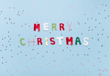 Merry Christmas and Happy New Year. Colorful letters on background with snow of confetti, copy spaceの写真素材