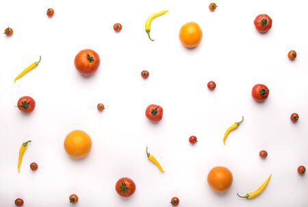Diet concept. Fresh and colored vegetables background with tomatoes and chili on whiteの写真素材