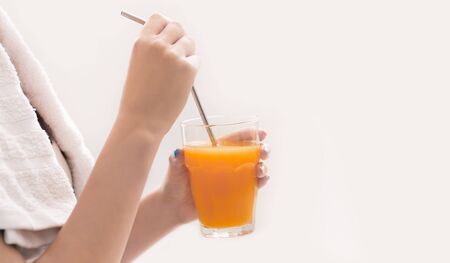 Replenish energy balance. Woman drink orange detox fresh juice after training, panorama, copy spaceの写真素材