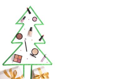 Christmas tree made of winter face care cosmetics on white background, panorama, copy spaceの写真素材