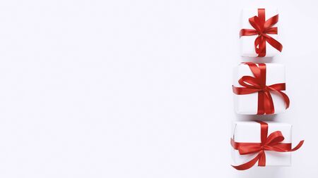 Tower stack of Christmas present boxes from the biggest to the smallest on white background, panorama, copy spaceの写真素材