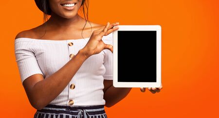 Great Application. Unrecognizable Girl Showing Tablet Computer Empty Screen Standing On Orange...
