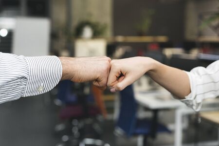 Business partners giving fist bump after complete a deal, close upの写真素材