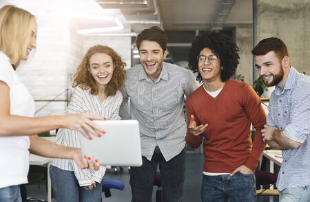 Business meeting and communications concept. Young creative team attending video conference via digital tablet at officeの写真素材