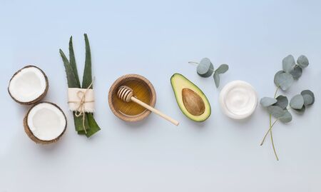 Homemade face and body mask of natural ingredients coconut, aloe, honey, avocado, blue background