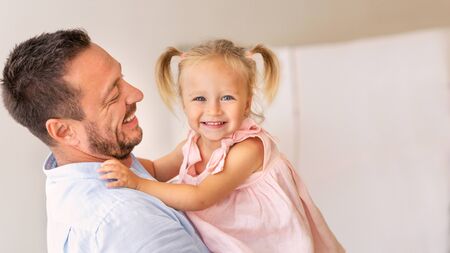 Happy Childhood. Loving dad with smiling little daughter looking at camera. Panorama, copy space