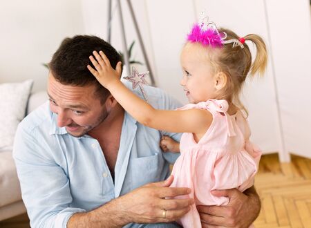 Happy Fatherhood. Millennial dad enjoying spending time with his lovely princess daughter