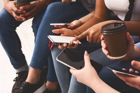 Gadgets addiction. Teenagers using phones, surfing social networks, closeupの写真素材