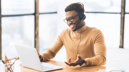 Friendly Operator. African american sales manager consulting client. Panorama, free space