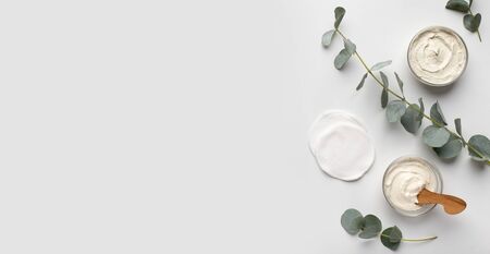 Homemade natural cosmetics. Organic creams with olive oil for face and body, white background, panorama, copy spaceの写真素材