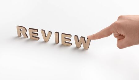 Rating concept. Woman touching review word of wooden letters on white background, panorama, copy...
