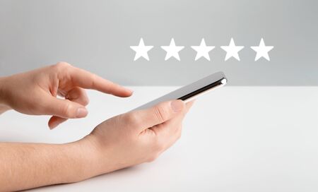 Application rating. Woman evaluating mobile app on cellphone over gray background, copy space