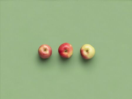 Organic concept. Apple minimalism on light green background, copy space