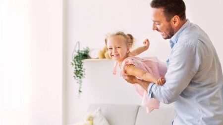 Weekend At Home. Daddy holding his little child, having good time. Panorama, free space