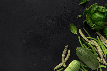 Superfood concept. Green detox vegetables creating healthy frame, black background with copy spaceの写真素材