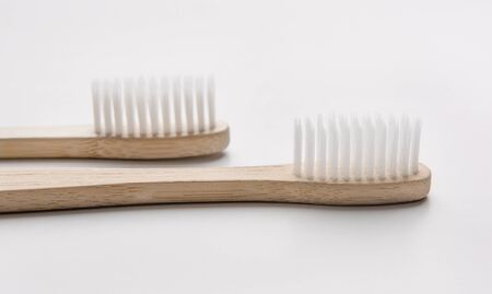 Eco friendly advertisement. Two bamboo natural toothbrushes on white background, panoramaの写真素材