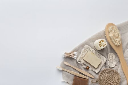 Spa organic natural cosmetic and eco friendly bath accessories on beige towel, white background, copy spaceの写真素材