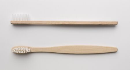 Eco natural bamboo toothbrushes on white background with greenery. sustainable lifestyle concept. zero waste flat lay, panoramaの写真素材