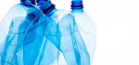 Mineral water bottles crushed and crumpled against white isolated background, panorama, copy spaceの写真素材